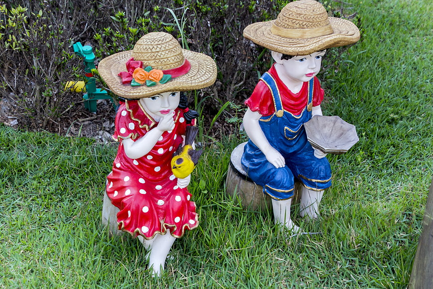 Colorful Garden Statues of Children in Straw Hats