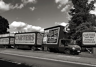 Vintage black and white photo of Carters Steam Fair trucks