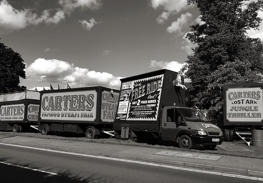 Vintage black and white photo of Carters Steam Fair trucks