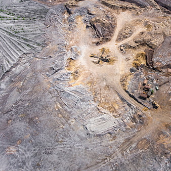Aerial view of open-pit mine with heavy machinery and excavation