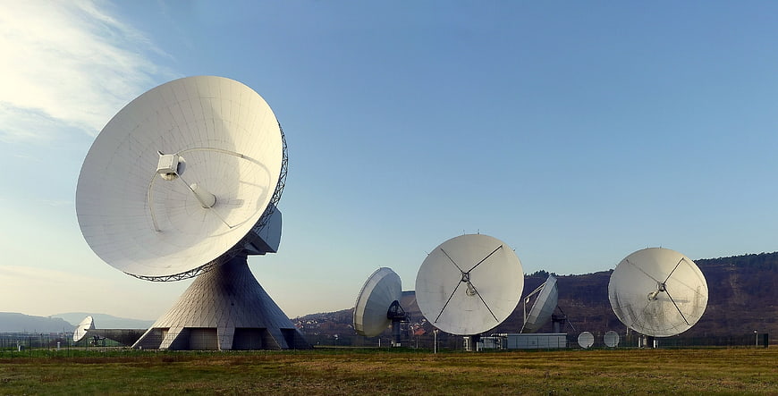 Large Satellite Dishes in a Field Under Blue Sky