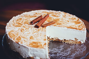 Sliced cinnamon cheesecake with powdered sugar swirls