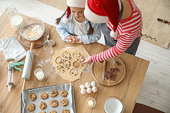 Mother and daughter baking Christmas cookies from above