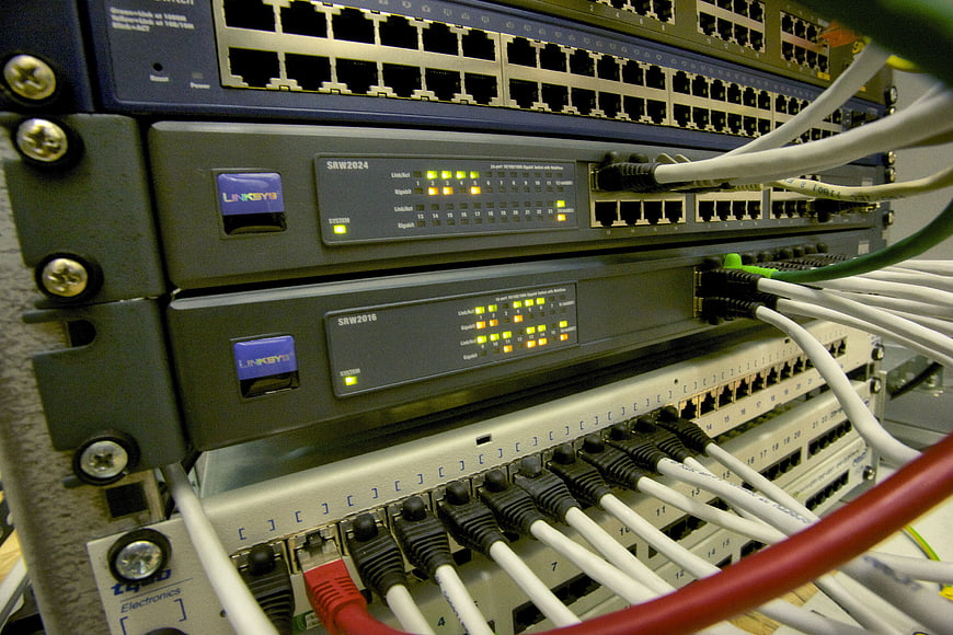 Close-up of network switches with ethernet cables in server rack