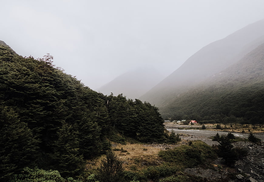 Misty Mountain Valley with River and Forest