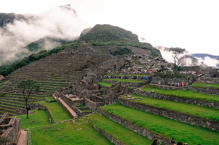 Machu Picchu ruins with terraces and misty mountains