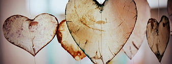 Rustic wooden heart decorations hanging on strings