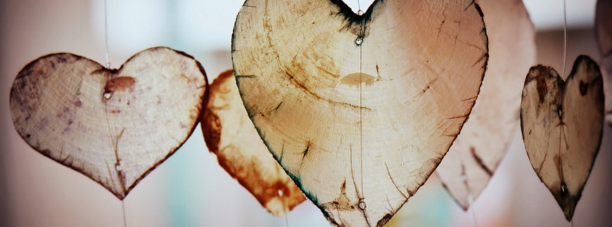 Rustic wooden heart decorations hanging on strings