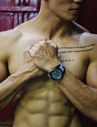 Muscular Shirtless Man with Watch and Chest Tattoo