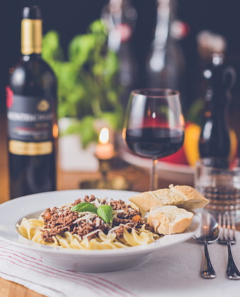 Pasta Bolognese with Red Wine and Bread on Table