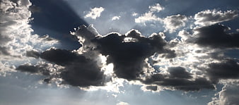Dramatic Sun Rays Breaking Through Dark Clouds