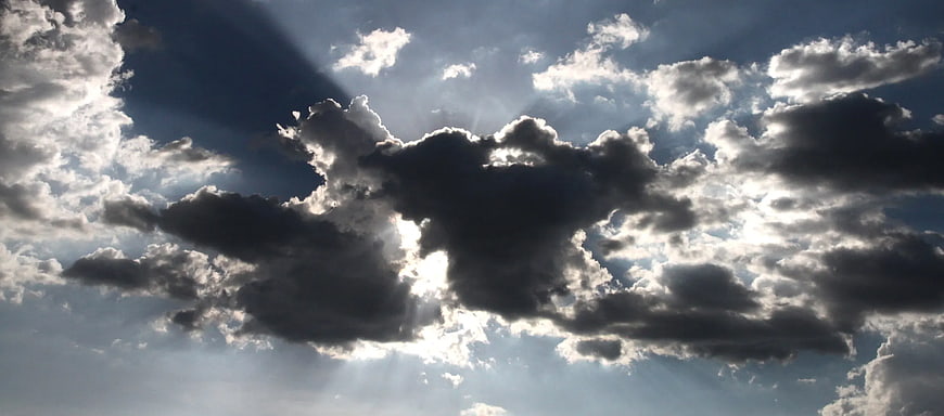 Dramatic Sun Rays Breaking Through Dark Clouds