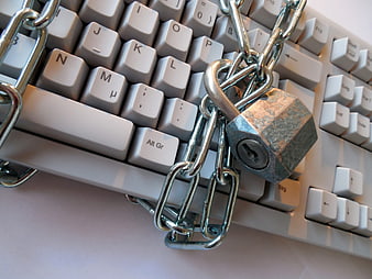 Computer Keyboard Secured With Metal Chain And Padlock