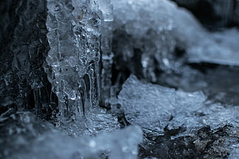Close-up of frozen icicles and ice texture on rock