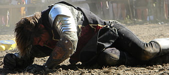Exhausted Medieval Knight Collapsing on Dusty Battlefield