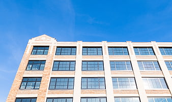 Modern Brick Office Building Facade Against Blue Sky