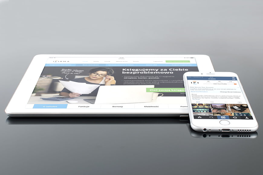 White tablet and smartphone mockup on gray surface