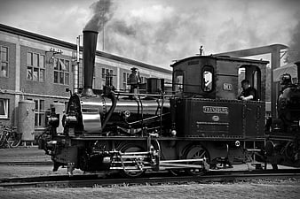 Vintage Black and White Steam Locomotive on Tracks