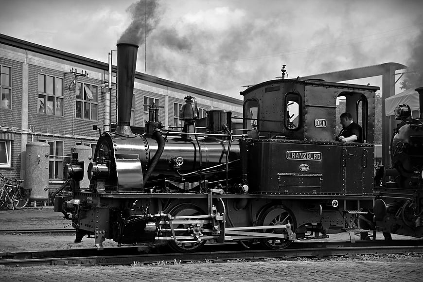 Vintage Black and White Steam Locomotive on Tracks