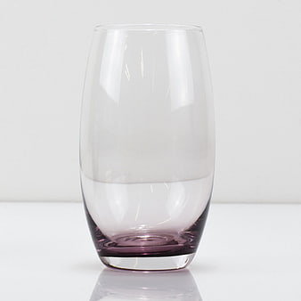 Elegant Stemless Glass with Purple Base on White Background