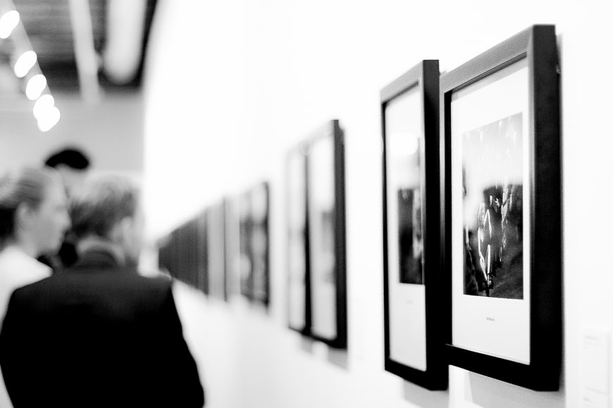 Black and white art gallery with framed photos on wall