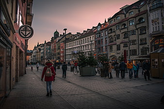 Pedestrian street in Innsbruck, Austria at dusk with pink sky