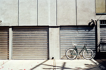 Green Bicycle Parked Against Concrete Wall