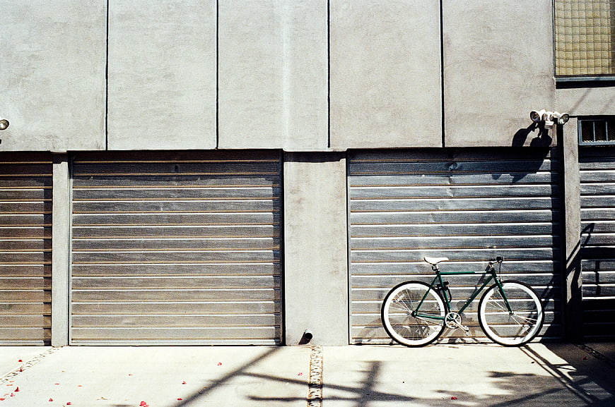 Green Bicycle Parked Against Concrete Wall