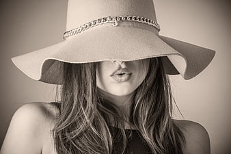 Fashionable woman wearing wide-brimmed hat with chain detail