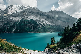 Turquoise Alpine Lake with Snow-Capped Mountains