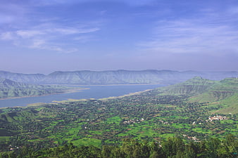 Aerial View of Green Valley with Lake and Mountains
