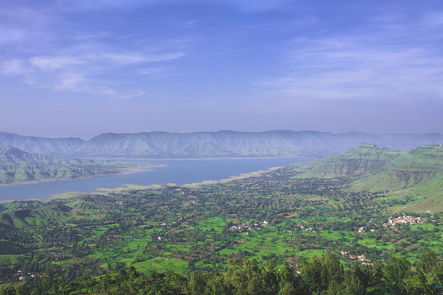 Aerial View of Green Valley with Lake and Mountains