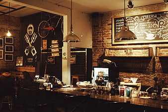 Rustic coffee shop interior with brick walls and chalkboard menu