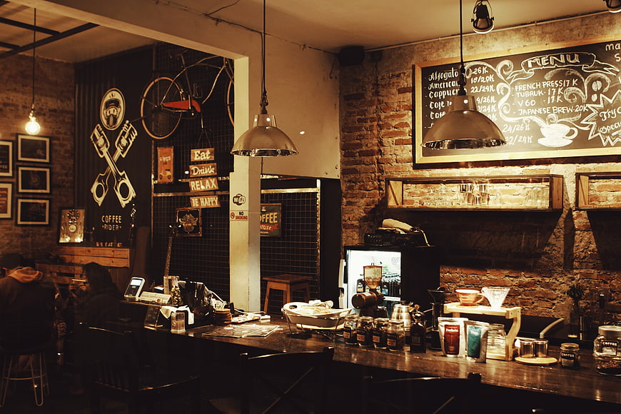 Rustic coffee shop interior with brick walls and chalkboard menu