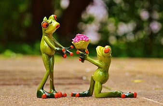 Cute frog figurines with pink roses proposal scene
