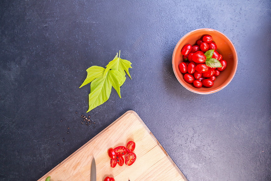 Top View of Cherry Tomatoes and Basil on Dark Background