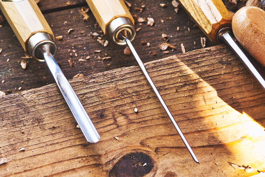 Woodworking Chisels On Rustic Wooden Workbench