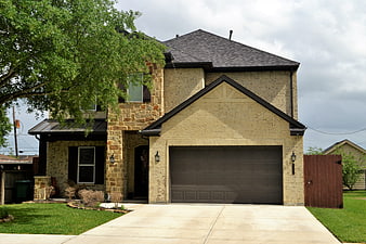 Two-Story Brick And Stone Suburban Home Exterior With Garage