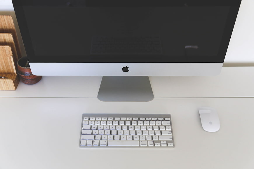 Minimalist Apple iMac Workspace on White Desk