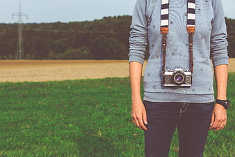 Man with Vintage Camera in Green Field