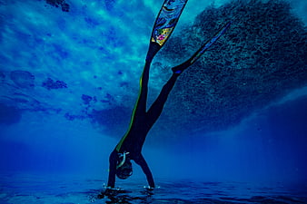 Underwater Freediver Performing Handstand in Blue Ocean