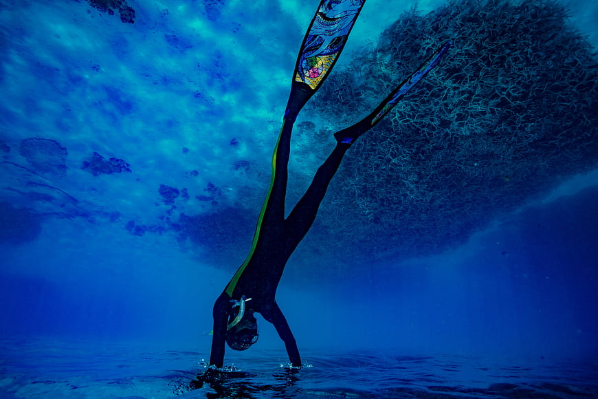 Underwater Freediver Performing Handstand in Blue Ocean