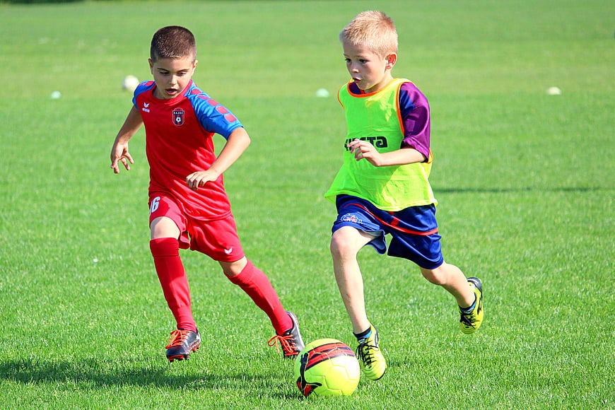 Two Young Boys Competing For Ball In Youth Soccer Match