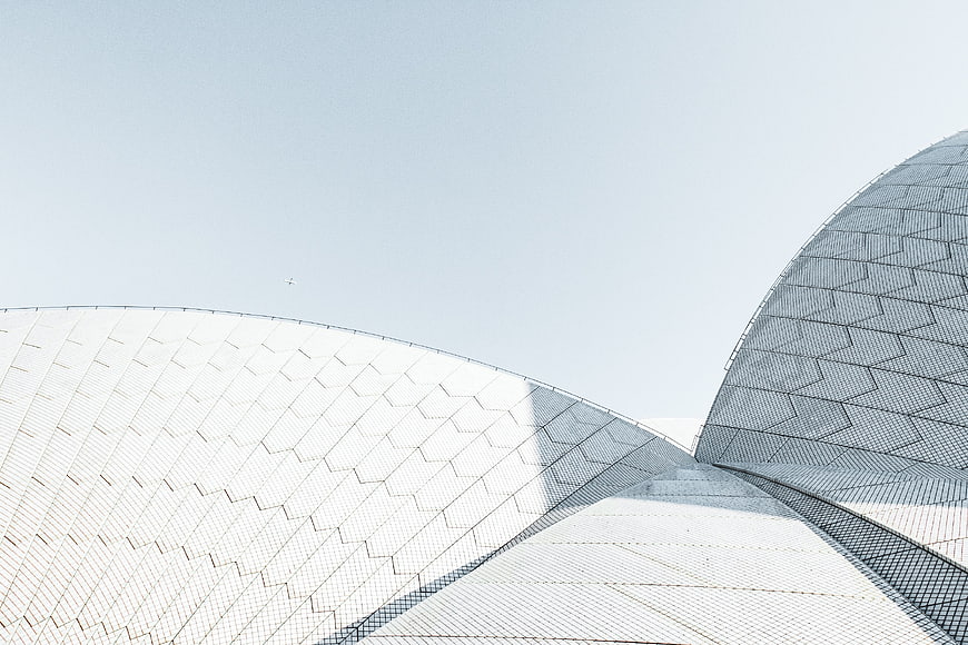 Modern white geometric dome architecture against blue sky
