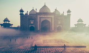Misty Morning View of the Taj Mahal with Tourists