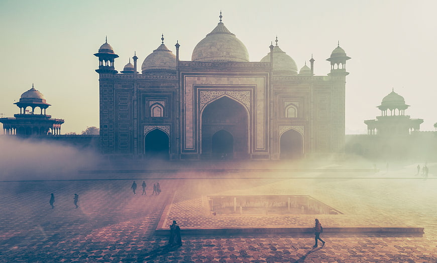 Misty Morning View of the Taj Mahal with Tourists