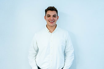 Portrait of smiling young man in white shirt