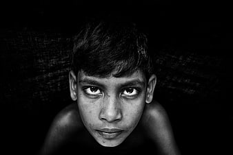 Intense black and white portrait of a young boy looking up