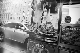 Black and white street food cart with pretzels and chicken
