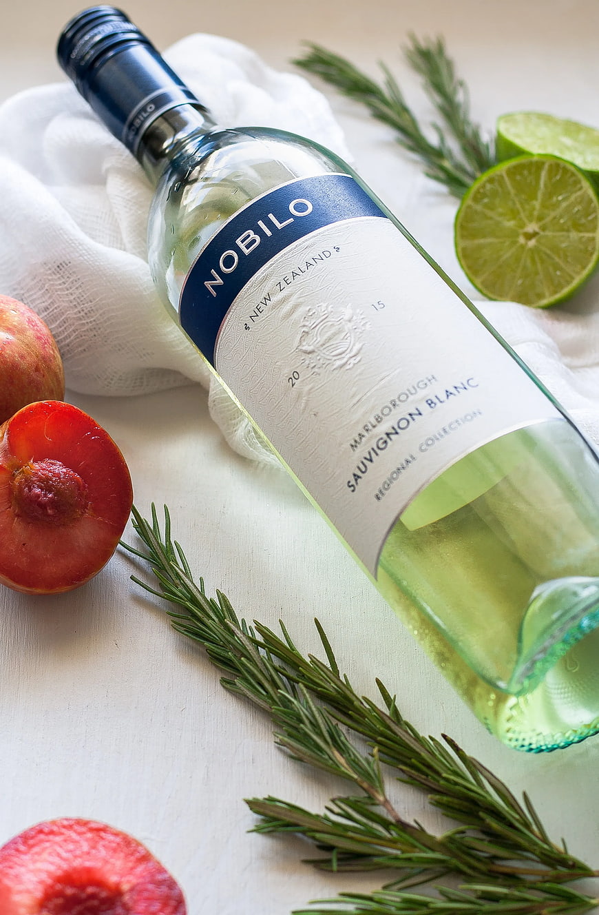 Nobilo Sauvignon Blanc wine bottle with peaches and rosemary